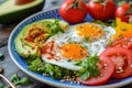 A colorful breakfast platter with fried eggs, fresh vegetables, and avocado slices