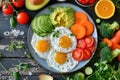 A colorful breakfast platter with fried eggs, fresh vegetables, and avocado slices