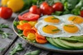 A colorful breakfast platter with fried eggs, fresh vegetables, and avocado slices