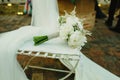 Colorful bridal bouquet on a white chair