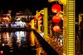 Colorful bridge in Hoian ancient town across the river with red lanterns at night. Hoi An, Vietnam - 28/01/2020