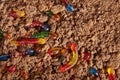 Colorful and bright assorted gummy worms in chocolate cake ground Royalty Free Stock Photo