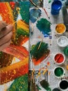 Colorful bright colors, brushes and abstract painting on newspaper background. cans of different colors