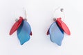 Colorful bright earrings on white background