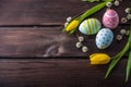 Colorful Easter eggs with yellow Tulip hand painted on a dark wooden background. Holiday spring card Royalty Free Stock Photo