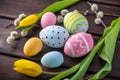 Colorful Easter eggs with yellow Tulip hand painted on a dark wooden background. Holiday spring card Royalty Free Stock Photo