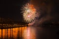 Colorful bright fireworks, salute of golden colors in night sky with reflection in the lake. Abstract holiday background Royalty Free Stock Photo