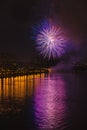 Colorful bright fireworks, salute of various colors in night sky with reflection in the lake. Abstract holiday Royalty Free Stock Photo