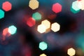 Colorful bright geometric forms traditional christmas lights on blurred dark blue background