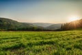 Golden epic sunrise rural panoramic landscape with a wide view over fields, forest, hills and valleys