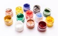 Colorful bright jars of gouache on a white background