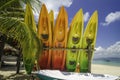 Colorful bright kayaks on the white sandy seashore with cloudy blue sky background Royalty Free Stock Photo