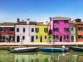 Colorful bright multi-colored buildings on the canal Bank of the island of Burano in Venice on a Sunny summer day Royalty Free Stock Photo