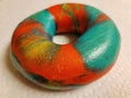 colorful bright rainbow bagel with many colors on counter Royalty Free Stock Photo