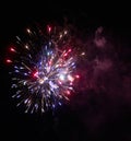 Colorful bright red and blue fireworks and smoke in the night sky background