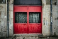 Colorful bright red wooden door in arched doorway