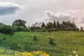 Colorful Bright Sunny Landscape with Russian country-house on hill in a middle of photo with a Bright Contrast cloudy Sky