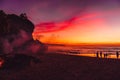 Colorful bright sunset or sunrise at tropical beach with ocean and waves Royalty Free Stock Photo