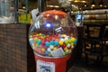 Colorful bubble gum in Coin operated gumball machine. Carousel Gumball Machine Bank kept outside a shop. - Dubai UAE January 2020