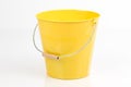 One yellow, empty iron/ metal bucket /pail/ container with handle isolated on white background.