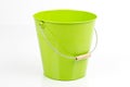 One green, empty iron/ metal bucket /pail/ container with handle isolated on white background.