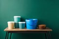 Colorful buckets on table on pastel color background