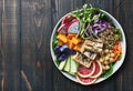 Colorful buddha bowl with grilled tofu and dragon fruit