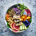 Colorful buddha bowl with grilled tofu and dragon fruit