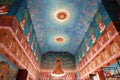 Colorful Buddhist art painting on the wall and ceiling