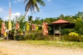 Colorful Buddhist prayer flags, pond and temple among green tropical nature in Wei Tuo Fa Gong Buddhist Temple in Pulau Ubin Royalty Free Stock Photo