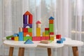 Colorful building blocks on white table in playroom Royalty Free Stock Photo