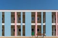 Colorful building facade with bench and dustbin. Royalty Free Stock Photo