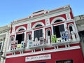 Red Building with Balcony Showing Miniature Storefront Facades in San Juan Puerto Rico USA