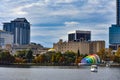 Colorful buildings ,autumn forest at Lake Eola Park and swan boat on cloudy sky background in Orlando Downtown area 2 Royalty Free Stock Photo