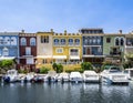 Colorful buildings near the sea with the boats parked in the front.