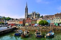 Colorful buildings, old boats and cathedral, Cobh harbor, County Cork, Ireland