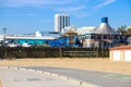 Colorful buildings on a pier at the beach with a bike path and silky brown sand with blue sky and clouds at Santa Monica Beach Royalty Free Stock Photo