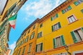 Colorful buildings in Pisa under a blue sky