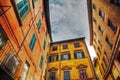 Colorful buildings in Pisa under a blue sky