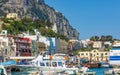 Colorful buildings, sightseeing boats, ferry with tourists in Marina Grande, Capri Island, Italy