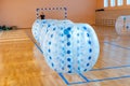 Colorful bumper ball bubble balloons in the sports hall. Equipment for team building sport game named bumper boll or Royalty Free Stock Photo