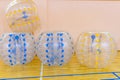 Colorful bumper boll bubble balloons in the sports center. Equipment for team building sport game named bumper ball or Royalty Free Stock Photo