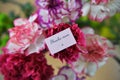 Colorful bunch of spring carnation flowers and miniature note for thank you mum Royalty Free Stock Photo