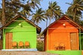 Colorful Bungalows on a Palm Beach in Goa, India. Royalty Free Stock Photo