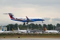 Colorful business jet landing in Boeing manufacturing plant site