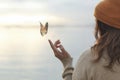 Colorful butterfly is laying on a woman`s hand Royalty Free Stock Photo