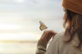 Colorful butterfly is laying on a woman`s hand Royalty Free Stock Photo