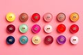 Colorful buttons on pink background. Flat lay, top view, Colorful thread spools and buttons on pink background, AI Generated