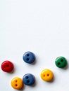 Colorful buttons on white background, red, yellow green blue or violet button, tiny little buttons closeup Royalty Free Stock Photo