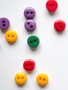 Colorful buttons on white background, red, yellow green blue or violet button, tiny little buttons closeup Royalty Free Stock Photo